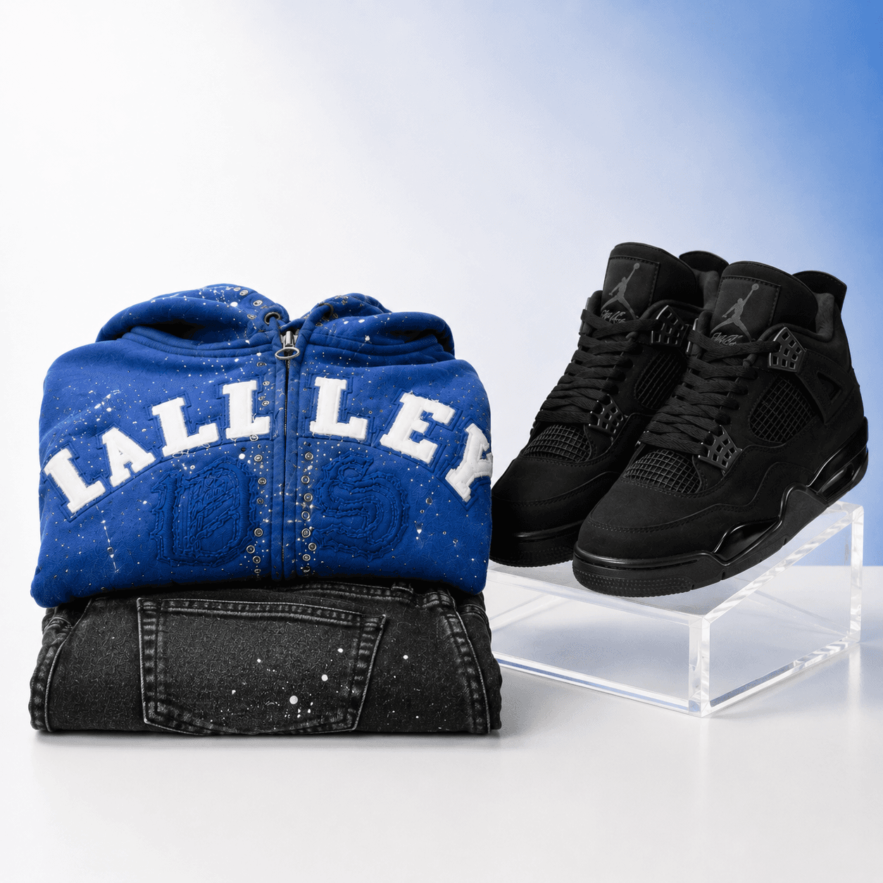 Folded apparel and black footwear arranged for wholesale distribution